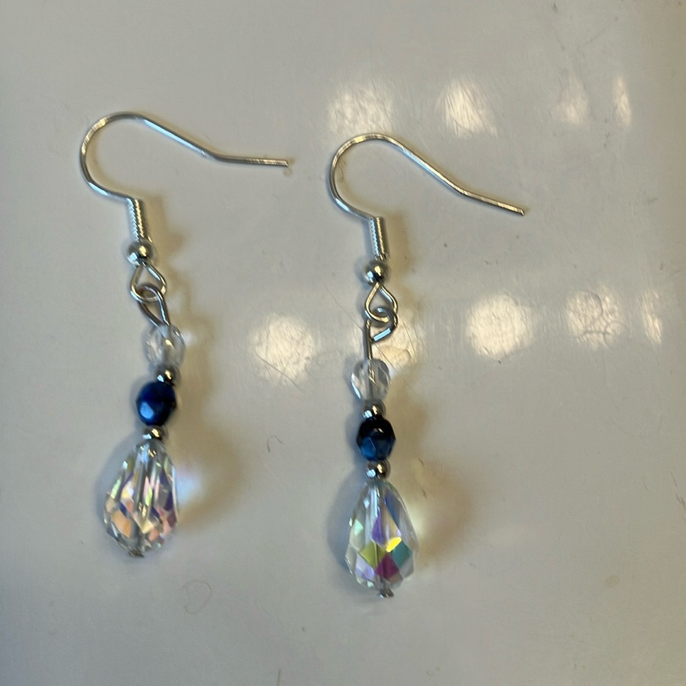 Clear teardrop shaped iridescent crystal beads with blue crystals earrings.
